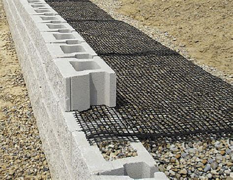 Geogrid retaining wall - Install Allan Block wall to designated height of first geogrid layer. Backfill and compact the wall rock and infill soil in layers not to exceed 8 in. (200 mm) lifts behind wall to depth equal to designed grid length before grid is installed. Cut geogrid to designed embedment length and place on top of the Allan Block units to back edge of the ...